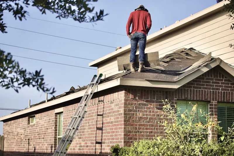 Professional roofer working on a residential roof in Tasker